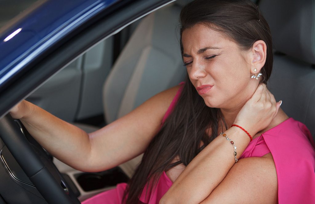 Woman suffering from neck pain, tired after long driving